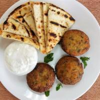 Kolokithokeftedes · Zucchini croquettes (3) made with herbs and feta cheese. Served with pita bread and tzatziki...