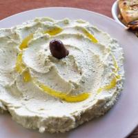 Spicy Feta Spread (TIROKAFTERI) · Spicy feta cheese spread infused with herbs. Served with pita bread.