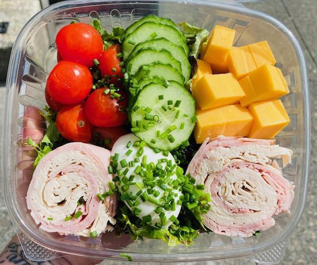 Chef Salad · Mixed greens, ham, turkey, tomato, cucumber, cheddar cheese, and hard boiled egg garnished with minced green onion. Comes with your choice of homemade dressing. ENTREE SIZE, I can't ever finish an entire salad!