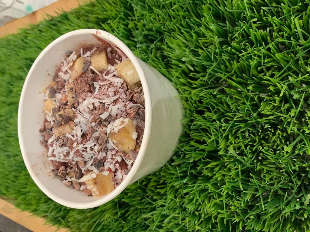 Coco Acai Bowl · Acai, almond butter, banana, cacao topped with banana, coconut flakes, cacao nibs, almond butter, blueberries, dried cranberries.