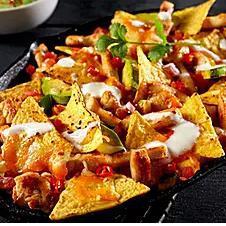 Nacho Supreme · Vegan. Nacho supreme includes nachos, tomatoes, lettuce, onions, olives, melted vegan cheese, and meatless beef. (2 layers). Nacho supreme for an additional charge.
