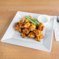 Boneless Buffalo Wings · Fresh chicken cubed and fried tossed in boom boom sauce served with blue cheese and celery.