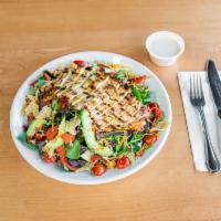 Fiesta Chicken Salad · Grilled chicken, grape tomatoes, red onion, sliced avocado, feta cheese and crispy tortillas...