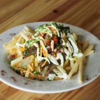 Asada Fries · Fresh french fries, our chimichurri, garlic sauce, cheese served with carne asada.