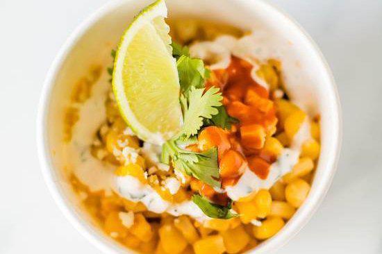 PIER St. Corn · Elote Style Corn off the cobb, cotija Mexican cheese grated, cilantro, ancho and valentina sauce.
