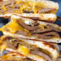 Mad Greek Quesadilla · Two Toasted Pita Breads filled with Imported Feta, Shredded Cheddar Cheese & Choice of G...