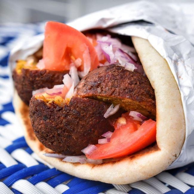 Falafel Sandwich · Falafel      Fried Chickpeas w/ Fresh herbs & Spices. Wrapped in a Toasted Pita w/Tomatoes & Red OnionsOur Sandwich is NOT served w/ Lettuce. Please Feel Free to Add for Free!Tzatziki Sauce Served on the Side