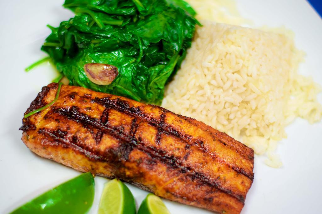 Salmon a la Parrilla · Grilled salmon filet, served with white rice and sautéed spinach. 