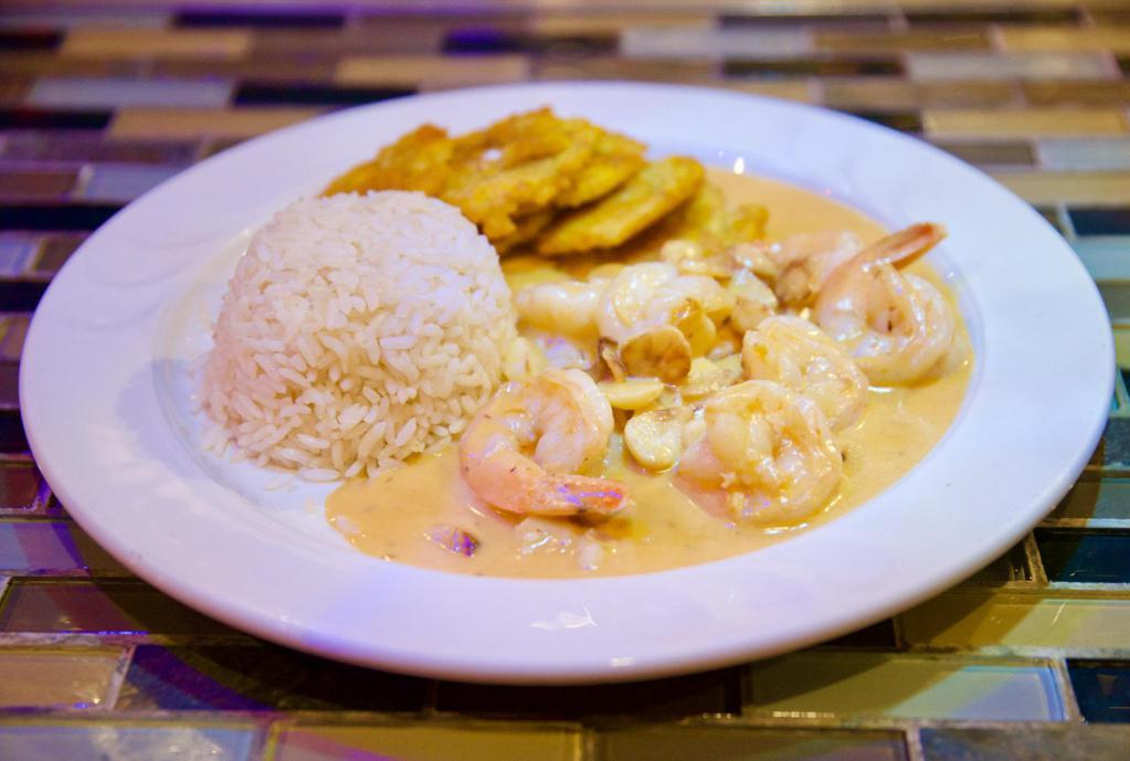 Camarones al Mojo de Ajo · Sauteed shrimps in garlic sauce. Served with white rice and tostones.
