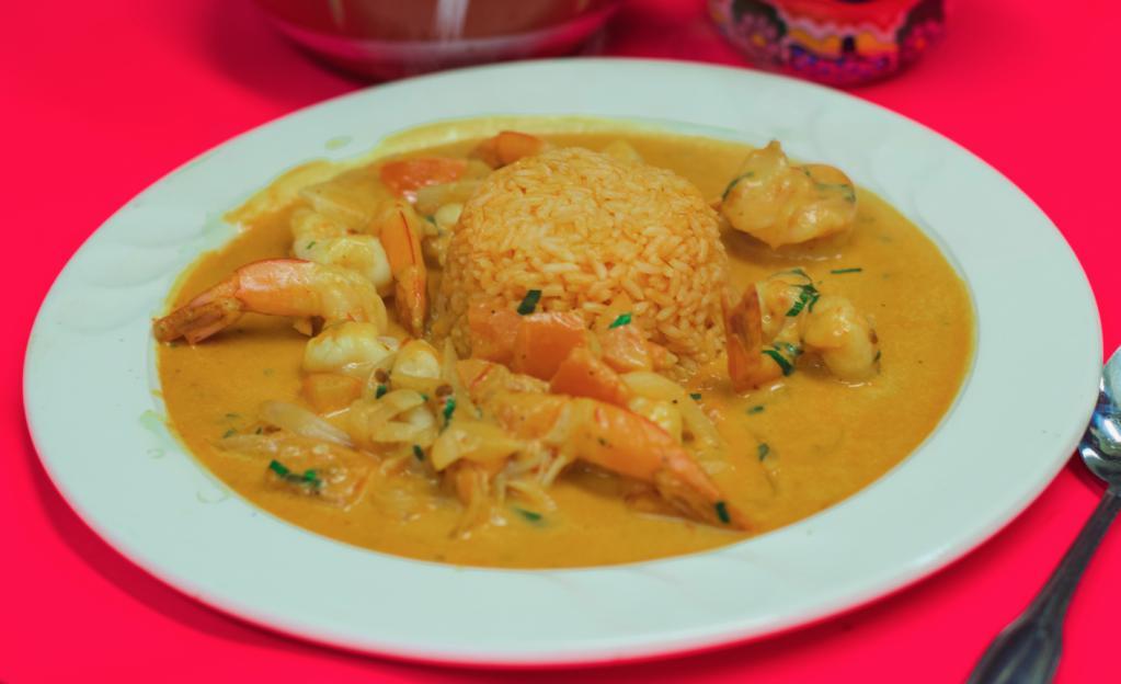 Camarones a la Diabla · Sautéed shrimp in chipotle sauce, onions, tomatoes. Served with rice and refried pinto beans.