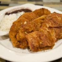 Pollo Empanizado · Breaded chicken breast served with white rice and beans.