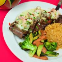 Mar y Tierra · Grilled shell steak with 3 shrimp, sauteed mixed vegetables, and white rice.
