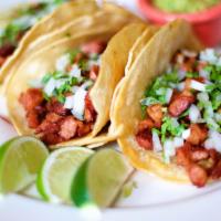 Chorizo Taco · Three soft corn tortillas filled with Mexican Sausage, topped with cilantro, onion and guaca...