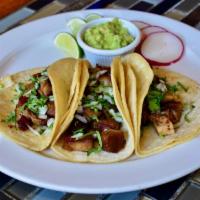 Carnitas Taco · Three soft corn tortillas filled with your choice of protein topped with cilantro and onion ...