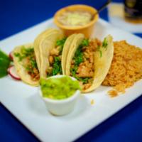 Grilled Chicken Taco · Three soft corn tortillas filled with your choice of protein topped with cilantro and onion ...