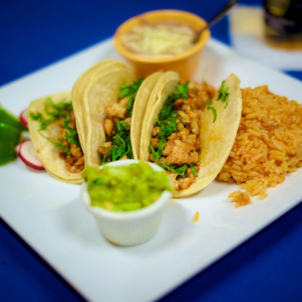 Grilled Chicken Taco · Three soft corn tortillas filled with your choice of protein topped with cilantro and onion and guacamole on the side.
