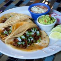 Grilled Steak Taco · Three soft corn tortillas filled with Grilled Steak, topped with cilantro and onion and guac...