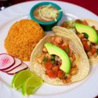 Shrimp Taco · Three soft corn tortillas topped with cilantro, onions, and pico de gallo. Served with rice ...
