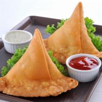 Vegetable Samosa · Deep-fried patties stuffed with potatoes, green peas and spices.  Served with  mint and tama...
