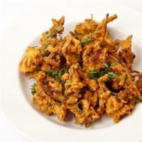 Onion Bhaji · Choped onion mixed with spices and ginger garlic. Dipped in gram flour batter and deep-fried...