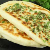 Paneer kulcha · Leavened bread stuffed with cottage cheese and cilantro. 