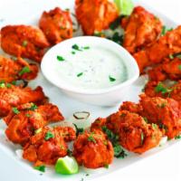 Chicken Tikka Kabab · Boneless chicken breast pieces marinated overnight and cooked in a clay oven.