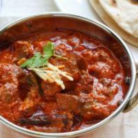 Lamb Vindaloo · Boneless lamb cooked with vinegar and potatoes finished with a thick vindaloo  gravy. Served...