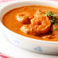 Prawn Tikka Masala · Prawn cooked with ginger, garlic and onions in a creamy tomato sauce. Served with portion of...