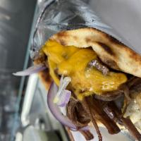 Beef Brisket · Slow cooked beef brisket in round pitta sandwich with cheddar cheese, horseradish sauce, red...