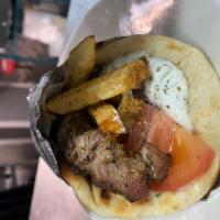 Pork souvlaki sandwich   · grilled pork stick seasoned with Greek herbs in round pitta topped with fresh cut fries, sli...