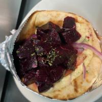 Red Beets sandwich (VEGETARIAN) · Red beets in round Pitta bread sprinkled w/ garlic, olive oil, salt & parsley, topped w/ sli...