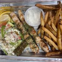 Chicken Souvlaki platter · Two skewers of white meat chicken breast seasoned with Greek herbs
