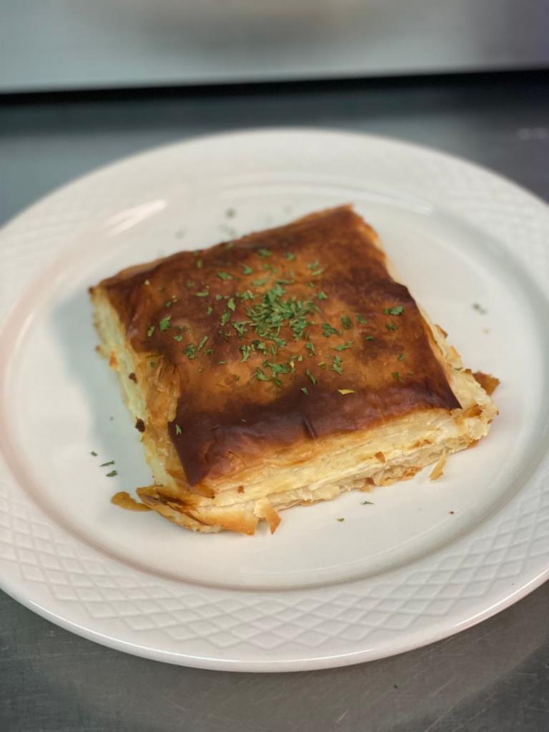 Tiropita · Phyllo pastry filled with feta cheese.