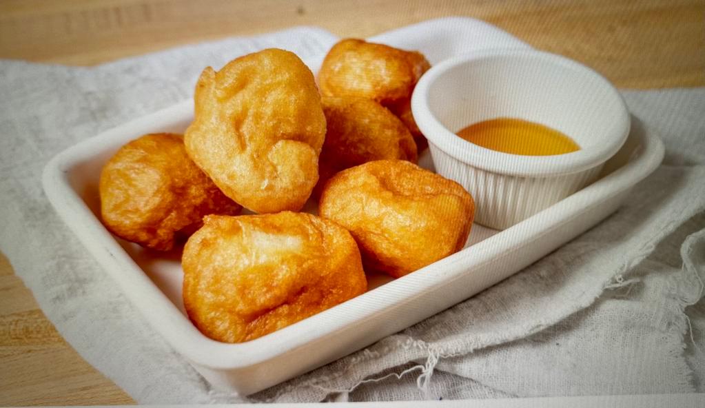 Loukoumades · Fried dough with honey and cinnamon or Nutella sauce.