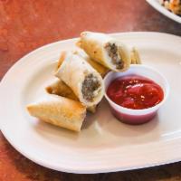 Cheesesteak Spring Rolls · Homemade crispy spring rolls filled with chipped steak and melted american cheese served wit...