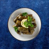 Dolma Delight · Grape leaves dumplings with rice, chopped tomatoes, parsley, green onions,lemon juice and ol...