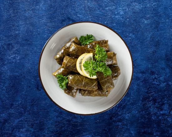 Dolma Delight · Grape leaves dumplings with rice, chopped tomatoes, parsley, green onions,lemon juice and olive oil