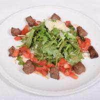 Arugula e Filetto Insalate · Diced seared filet mignon, baby arugula and shaved Parmigiano Reggiano.