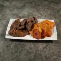 Tostones con Carne Frito · Fried green plantain with fried steak.