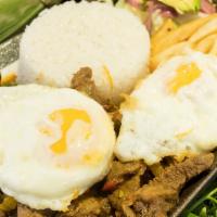 Churrasco Tipo Bistec · Steak in onions, sauce, rice, fried eggs, french fries and salad, Ecuadorian style.