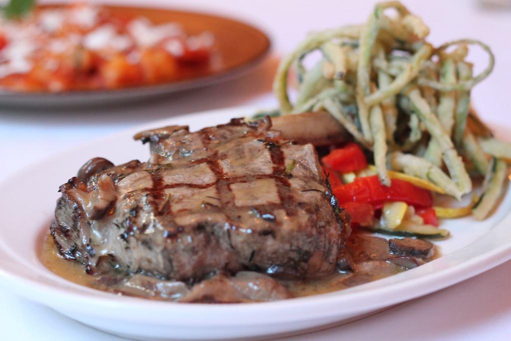 Costoletta di Vitello alla Griglia · Grilled veal chop. Served with roasted potatoes and string beans.
