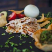 Quesadilla · Melted jack cheese in a flour tortilla with guacamole, sour cream, fresh salsa and chips.