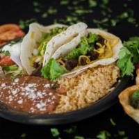 Taco Plate · Your choice of 2 soft flour tortillas with chopped onion and cilantro, choice of beans, red ...