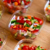 Israeli Salad · Israeli salad with Persian cucumbers, cherry tomatoes, carrots, onions, and radish.