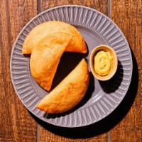 Empanadas · Deep fried half moon corn dough* filled with your choice of meat. One won’t be enough!. Orde...