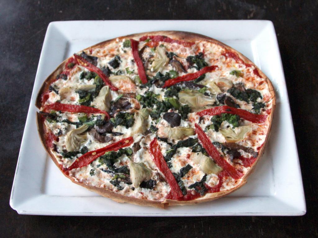 The Vegetarian Pizza · House marinara sauce, broccoli rabe, artichoke hearts, piquillo peppers, mushroom medley and fresh mozzarella.