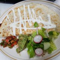 17. Quesadillas · Folded homemade tortilla with oaxaca cheese, lettuce, red tomato, sour cream and cotija chee...