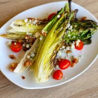 Grilled Romaine Wedge Salad · Grape tomatoes, crumbly bleu, BBQ bacon, and balsamic.