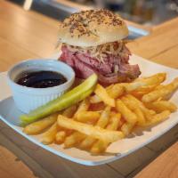 Beef on Weck Sandwich · Shaved prime rib on a Kimmelweck roll with crispy onions served with au jus and horseradish ...