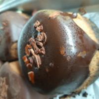 Quadruple Chocolate Cheesecake · A chocolate crumb base, chocolate cheesecake, topped with a ganache fudge and chocolate shav...